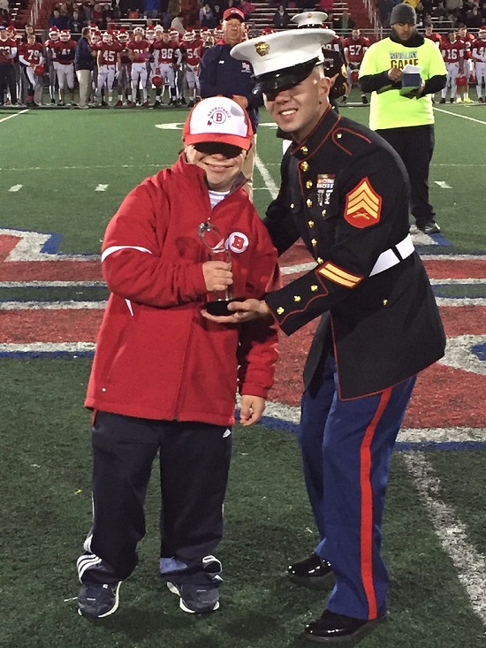 Here Coach Bentivegna is receiving his Great American Rivalry 2015 Hall of Fame trophy from the United States Marines. Photo Credit: United States Marines